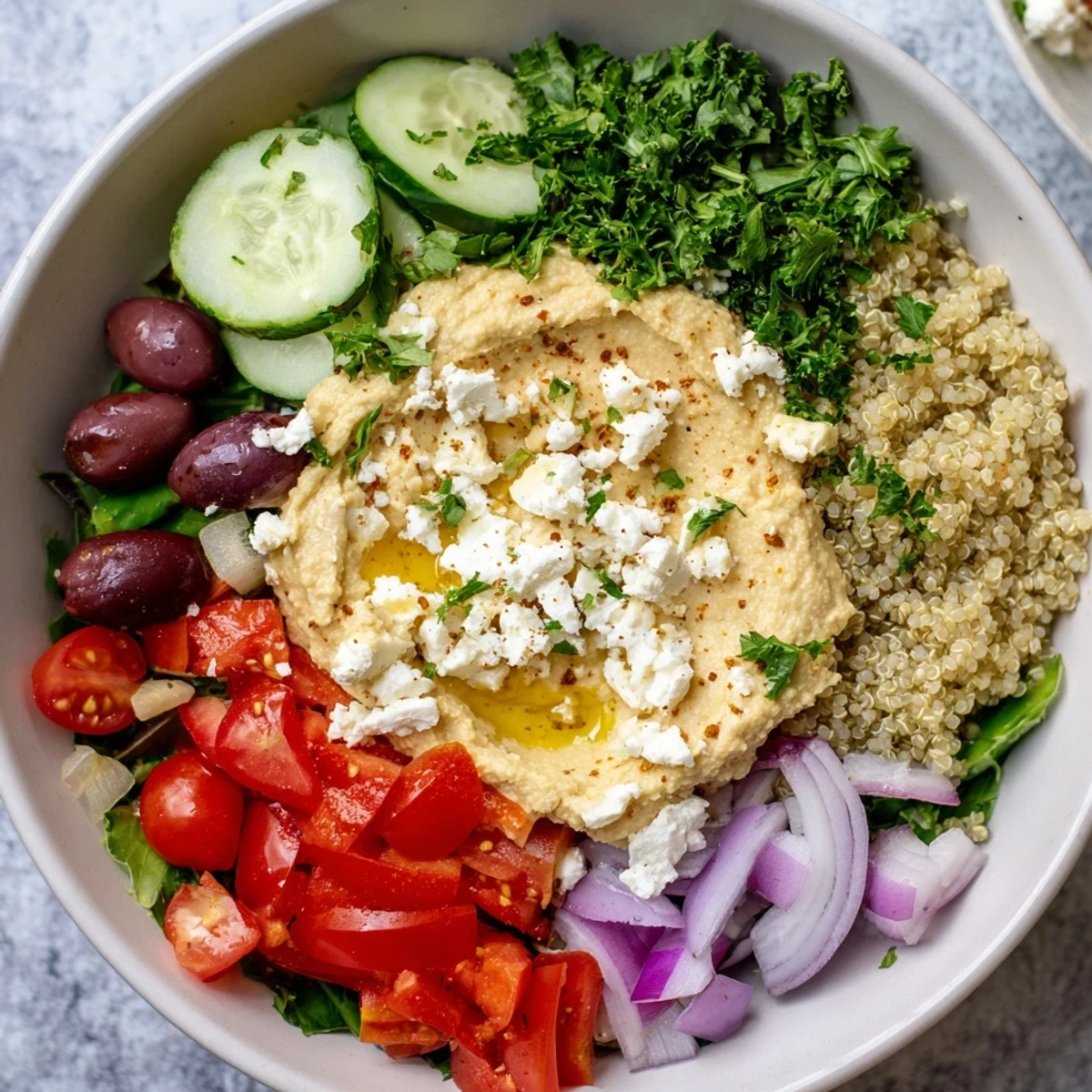 A vibrant Mediterranean Hummus Bowl with creamy hummus, fresh diced cucumber, and cherry tomatoes.