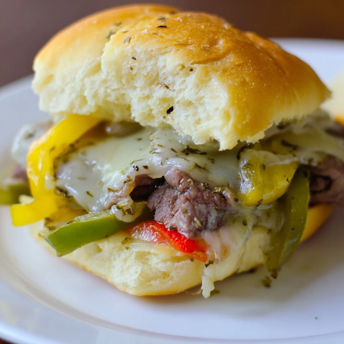 Savory MVP Philly Cheesesteak Sliders with melted cheese and toasted buns, served warm on a plate.