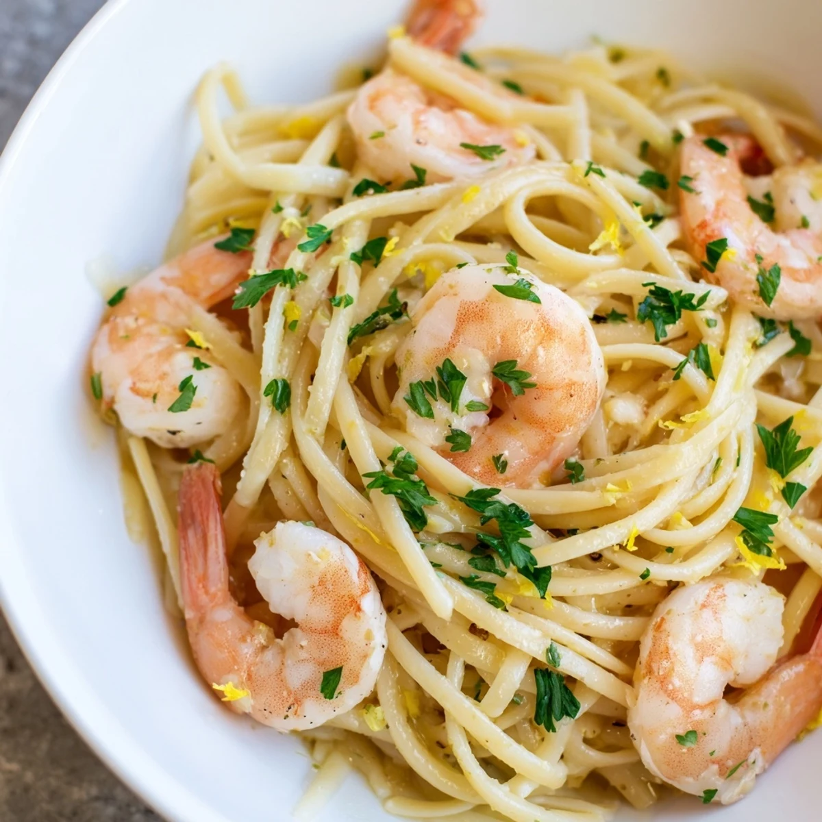 Plated Lemon Shrimp Pasta with Garlic, showcasing al dente strands and a light olive oil sauce ready to enjoy.