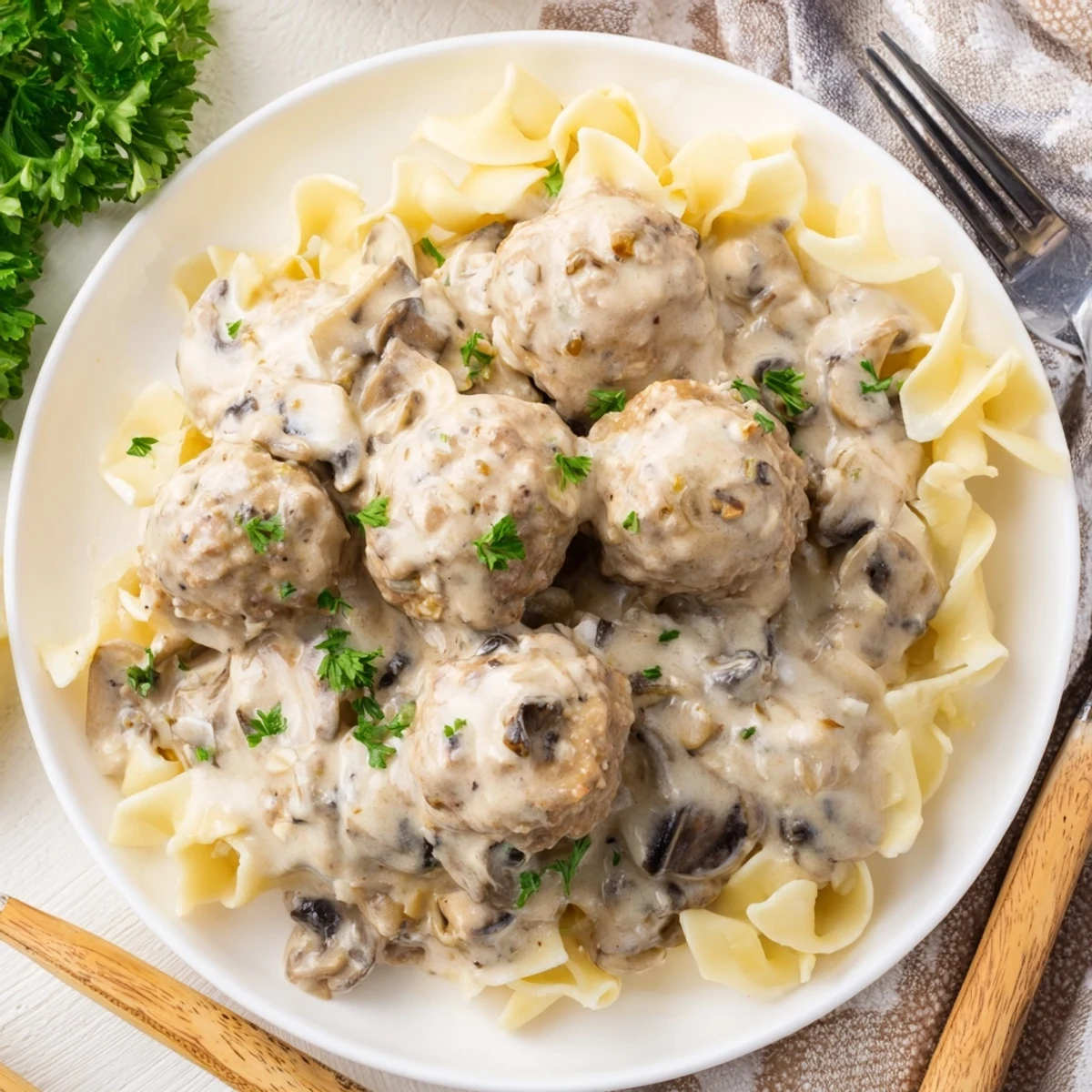 Savory turkey meatball stroganoff simmering in a rich sauce, accompanied by golden mushrooms and wide egg noodles.  