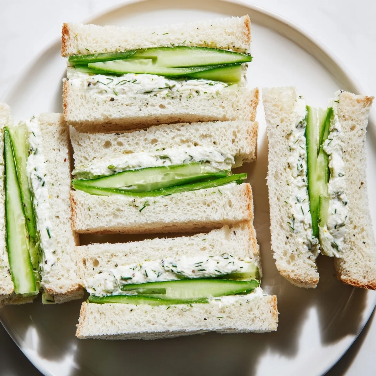 Delicate Green Cucumber Sandwiches with Cream Cheese offer a refreshing bite, perfect for elegant parties or afternoon tea gatherings.