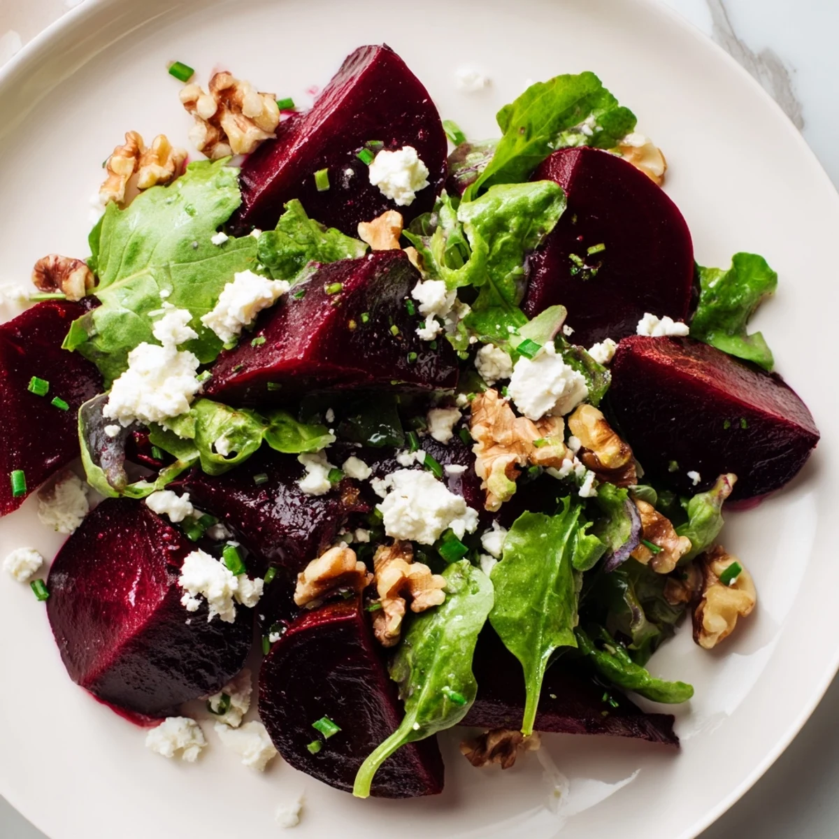 Freshly toasted walnuts top the Roasted Beet Salad with Goat Cheese for crunch beside tangy vinaigrette.