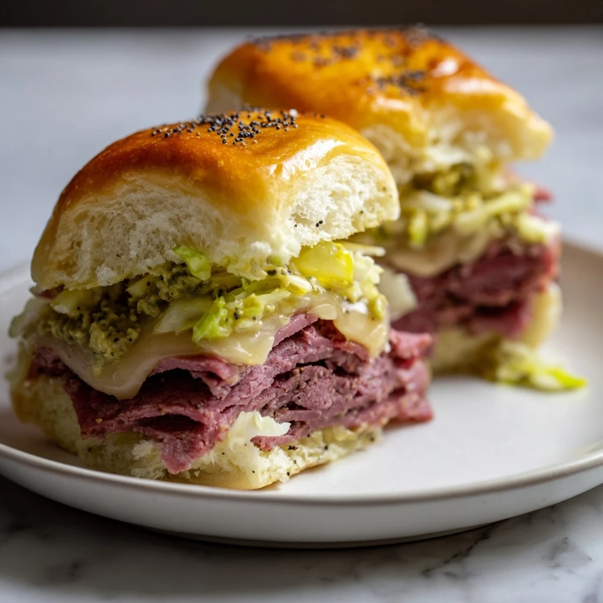Warm Corned Beef Sliders with Stone Ground Mustard and Swiss cheese, baked golden on soft buns.