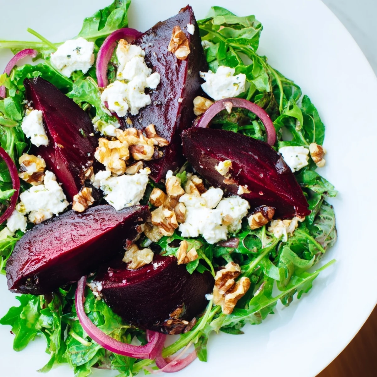 Vibrant Roasted Beet Salad with Goat Cheese showcases ruby beets, creamy crumbles, and toasted walnuts on arugula, drizzled with tangy vinaigrette.