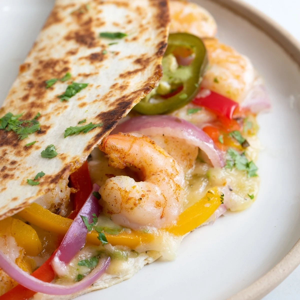 Golden, crispy Shrimp Fajita Sheet Pan Quesadillas are filled with juicy roasted shrimp, colorful bell peppers, and melted Mexican cheese blend.