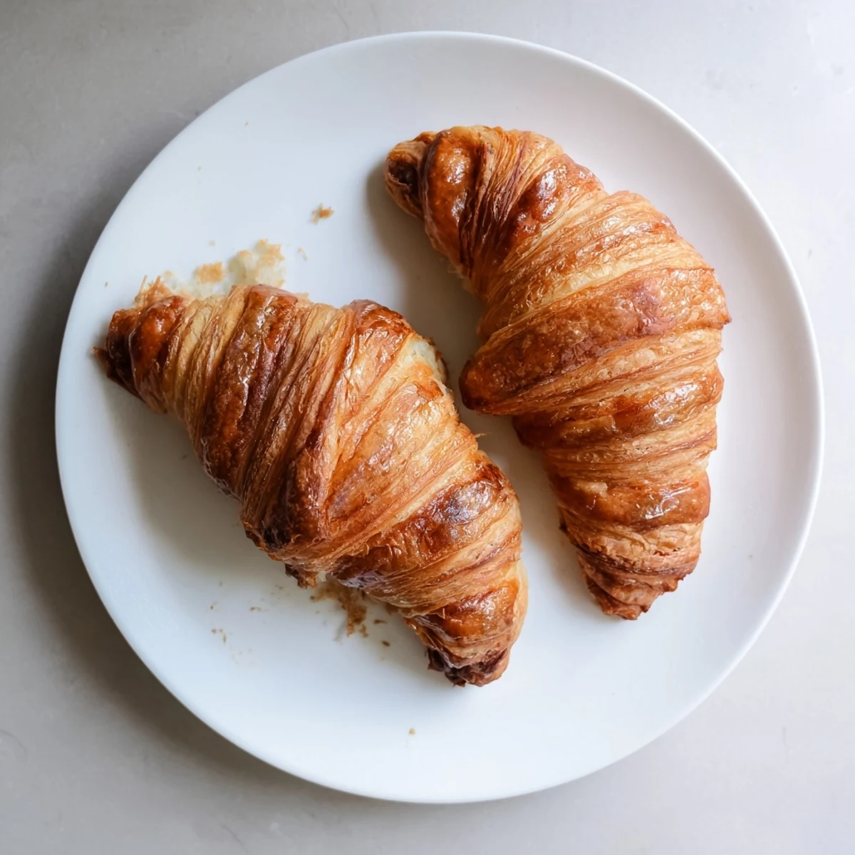 Overhead view of gluten-free croissant pastry dough laminated with butter, showing the light, airy layers in a food blog shot.