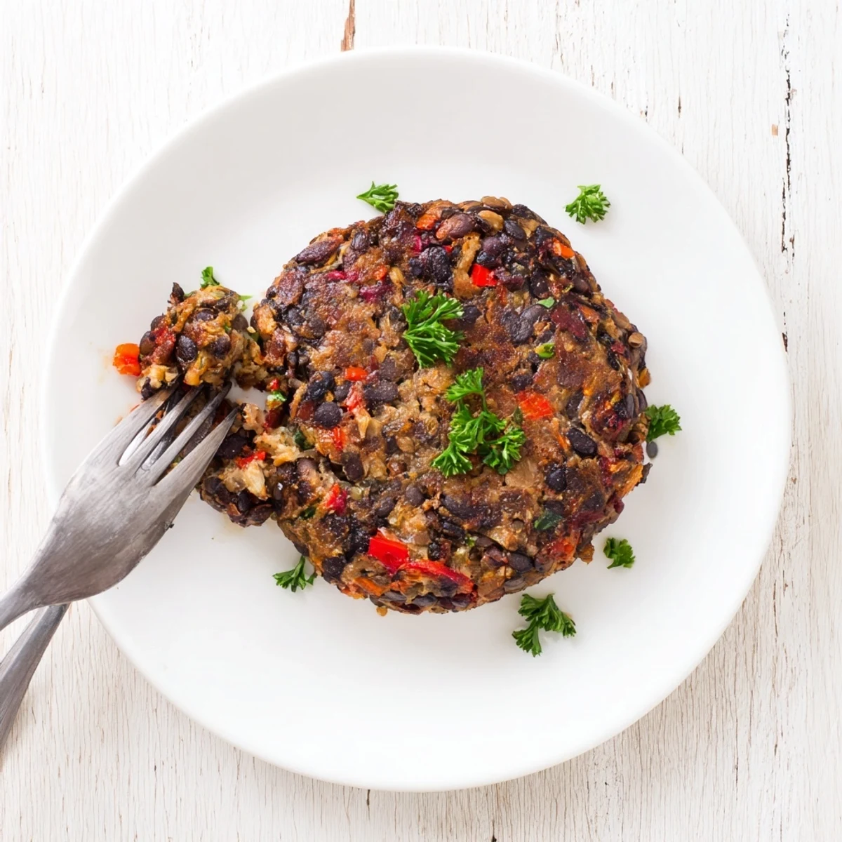 Golden-brown, sizzling Mushroom Veggie Burgers fresh from the skillet, served on a toasted bun with lettuce and tomato.