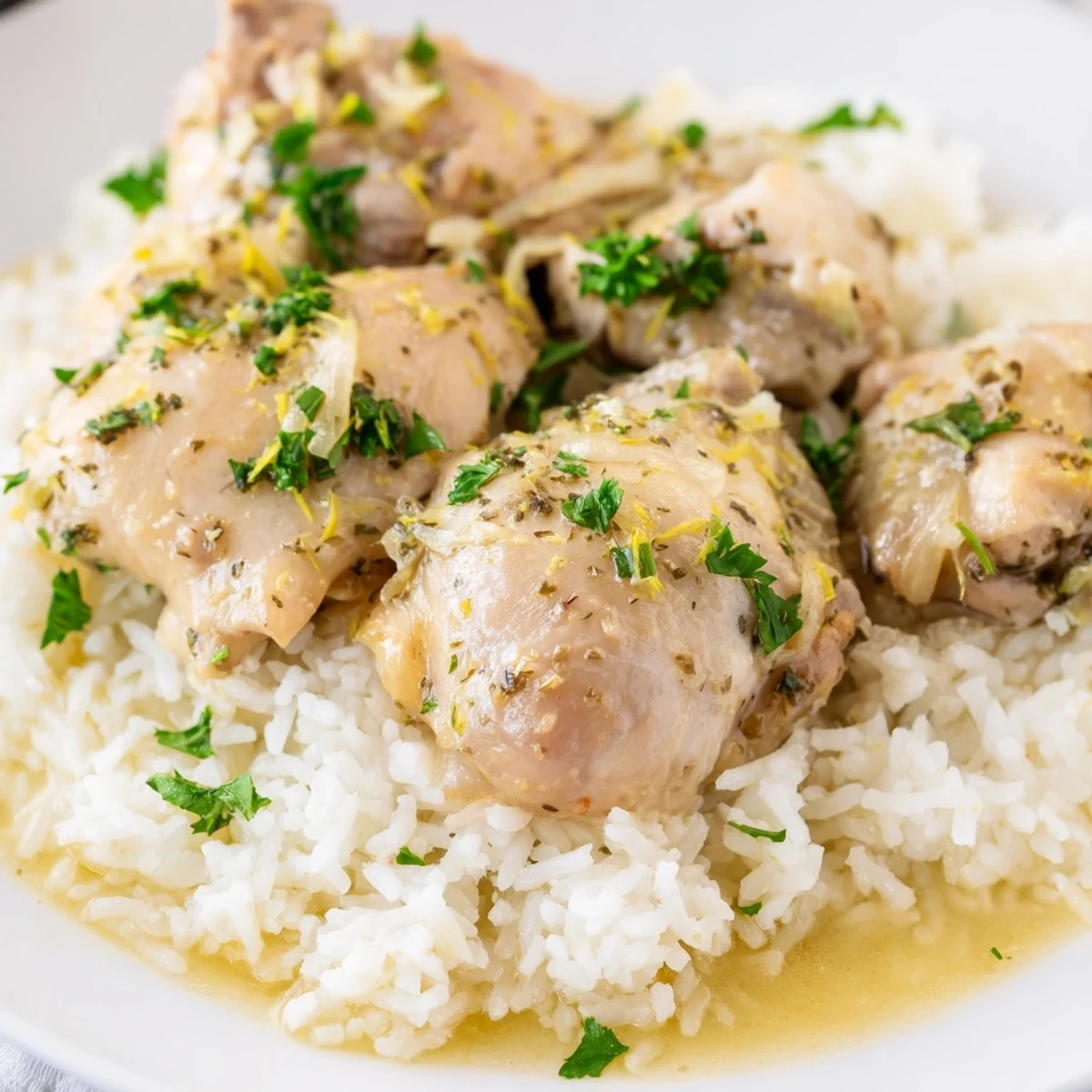 Tender juicy lemon herb chicken served with rice garnished with fresh green parsley