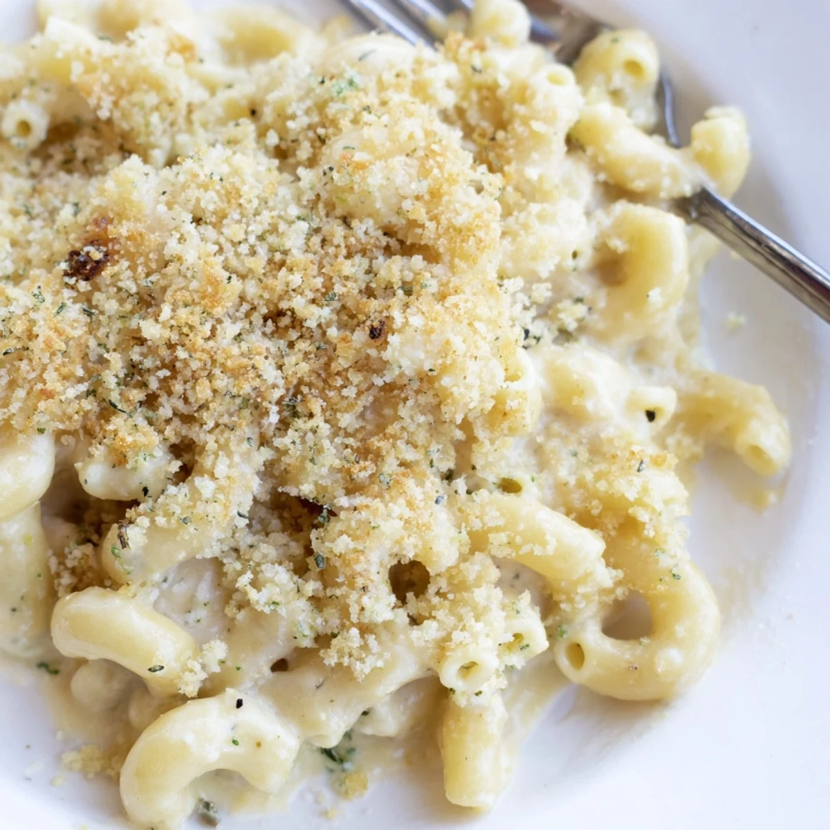 Gooey herbed Boursin mac and cheese with sharp cheddar sauce coating elbow pasta