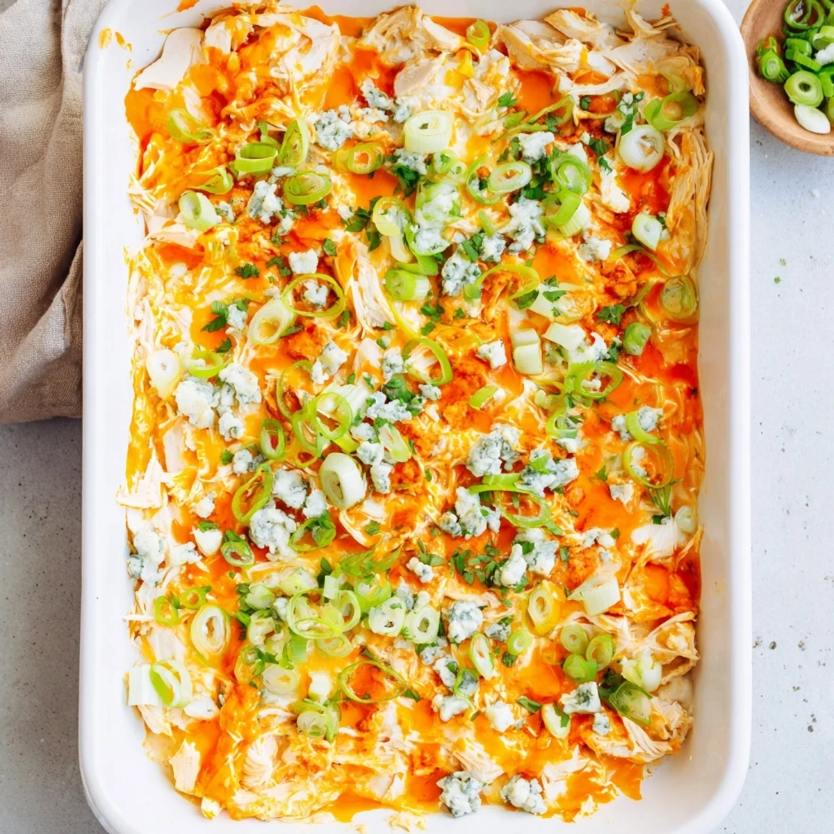 Spicy Buffalo Chicken Cheese Bake served bubbling hot with blue cheese crumbles and parsley