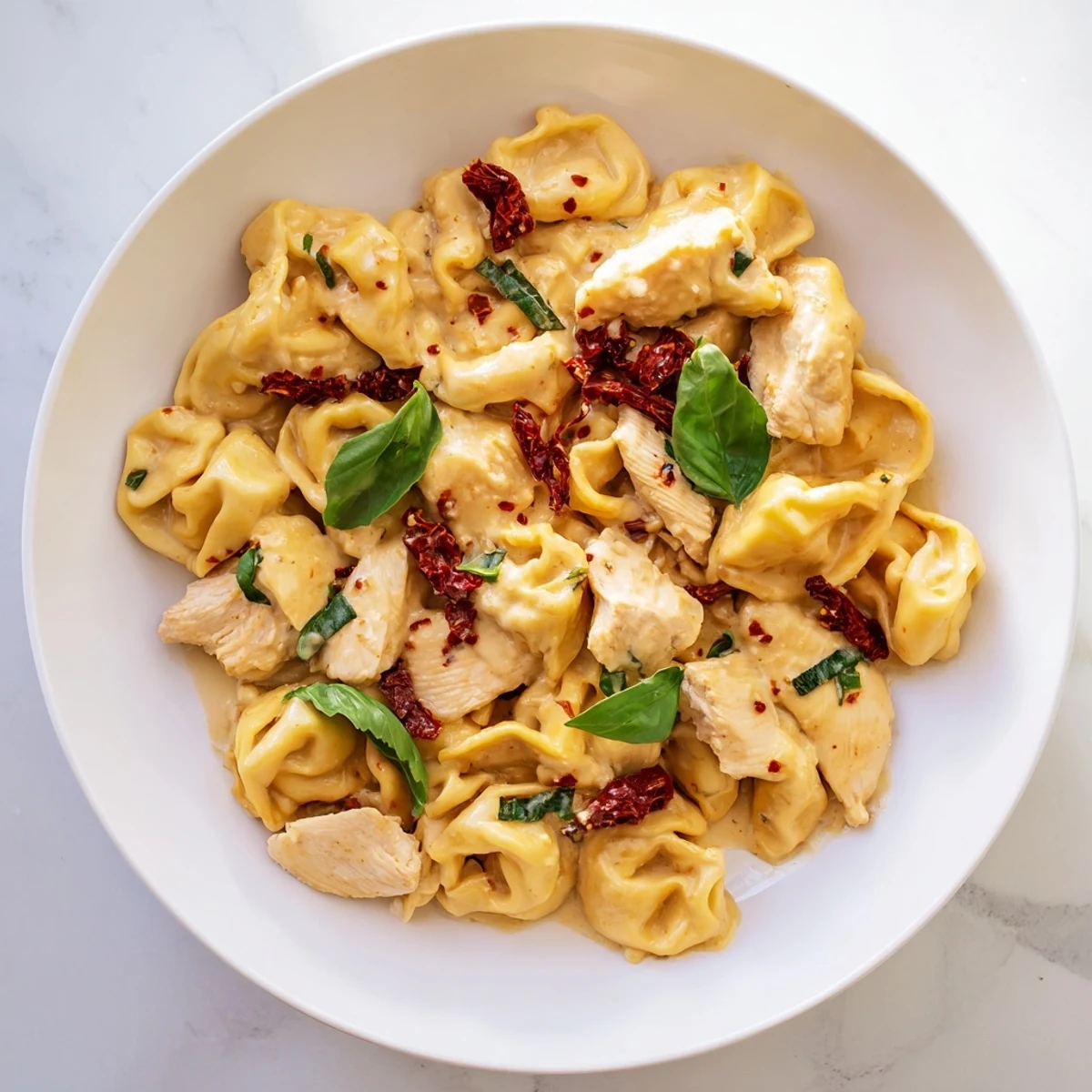 Creamy Marry Me Chicken Tortellini Skillet with golden chicken and cheese tortellini in rich parmesan sun-dried tomato sauce