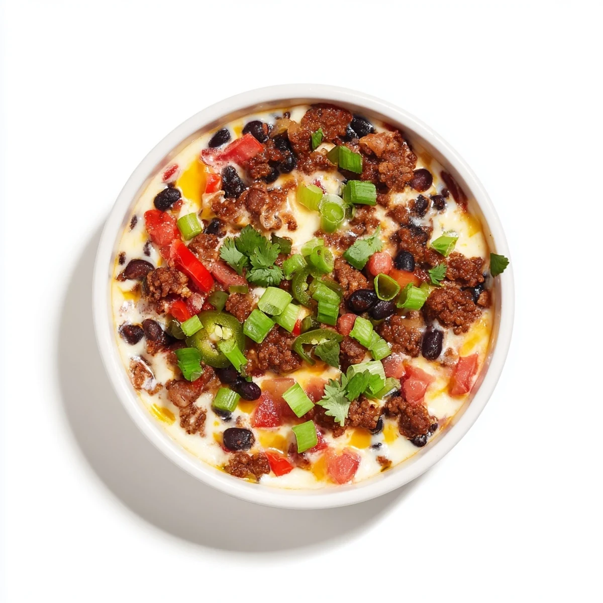 Creamy tex-mex cheese dip with chorizo black beans and peppers served with tortilla chips