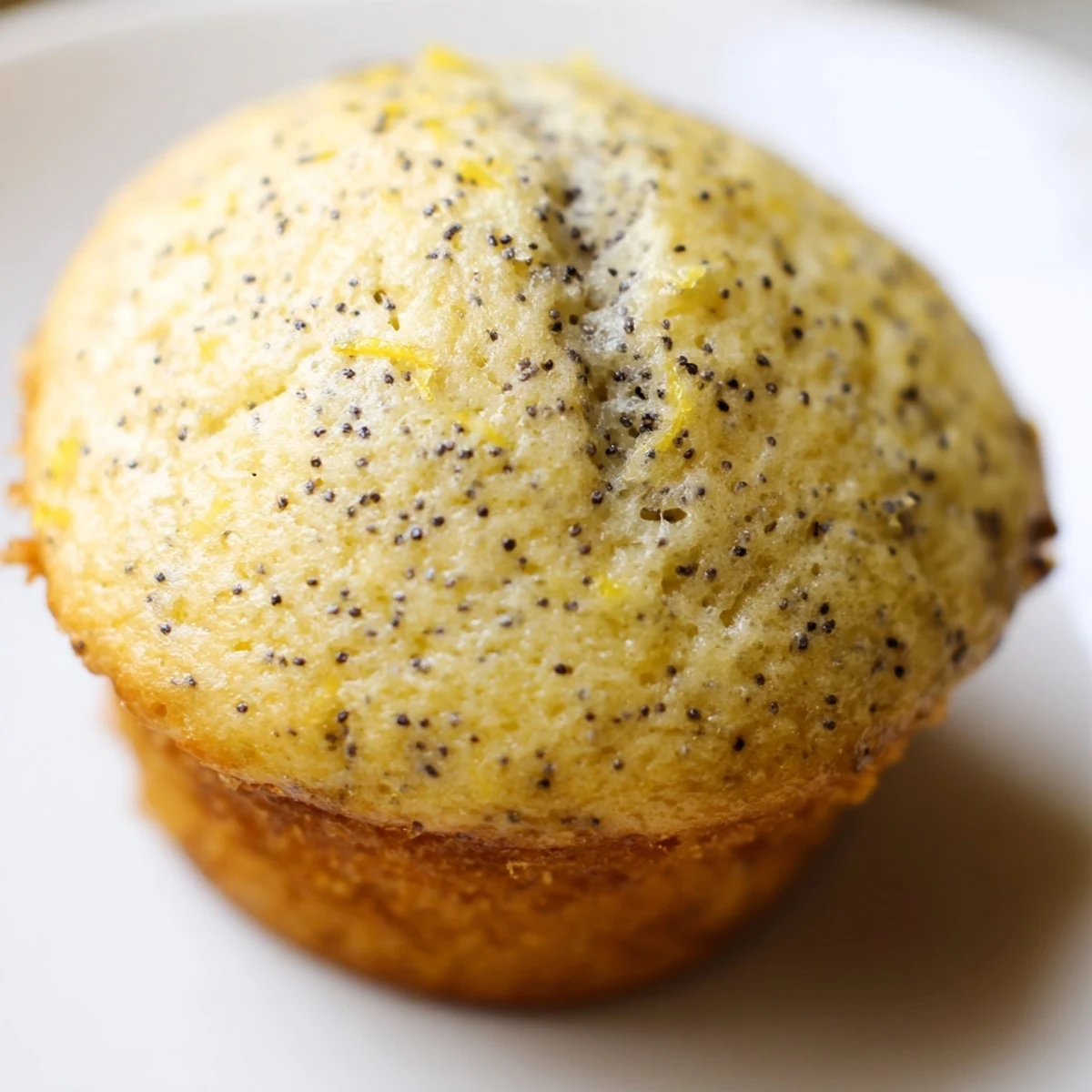 Moist Lemon Poppy Seed Muffins with golden domed tops fresh from the oven