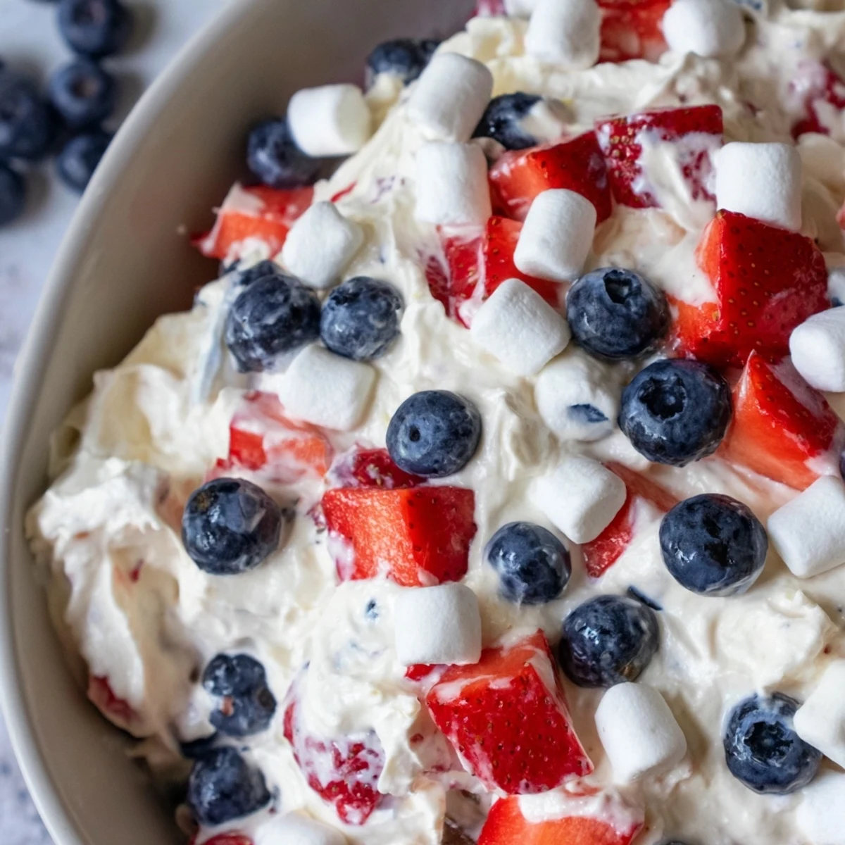 Red White Blue Cheesecake Salad in a chilled serving bowl with fluffy marshmallows