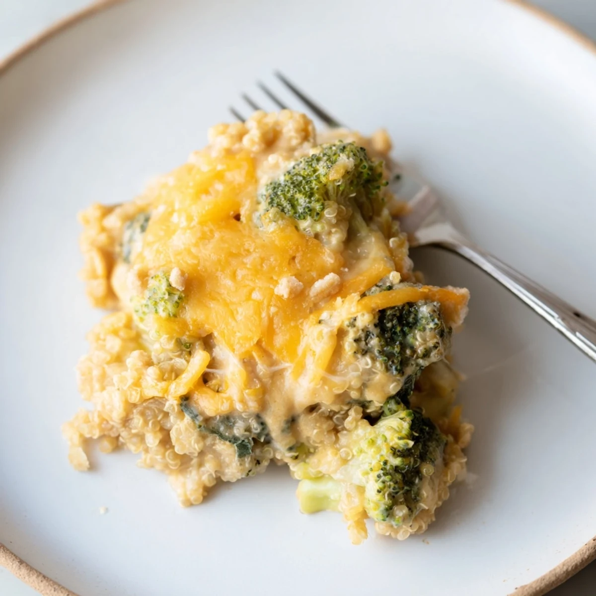 Bubbly vegetarian broccoli quinoa casserole served warm in a 9x13 baking dish