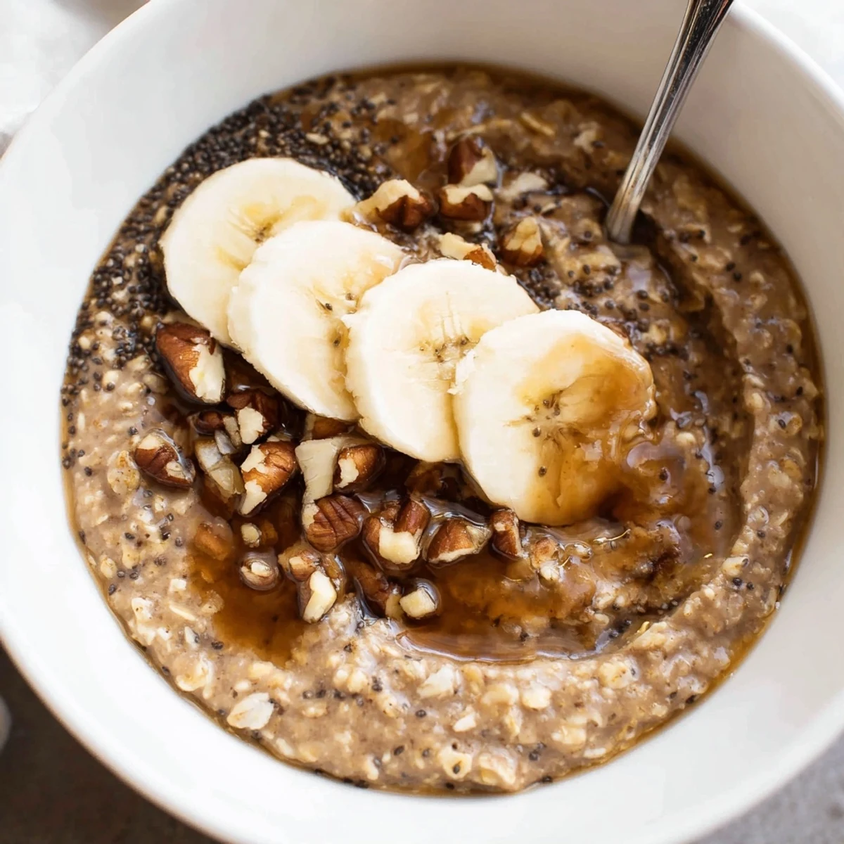 Creamy Brown Sugar Coffee Overnight Oats topped with sliced banana and toasted pecans.