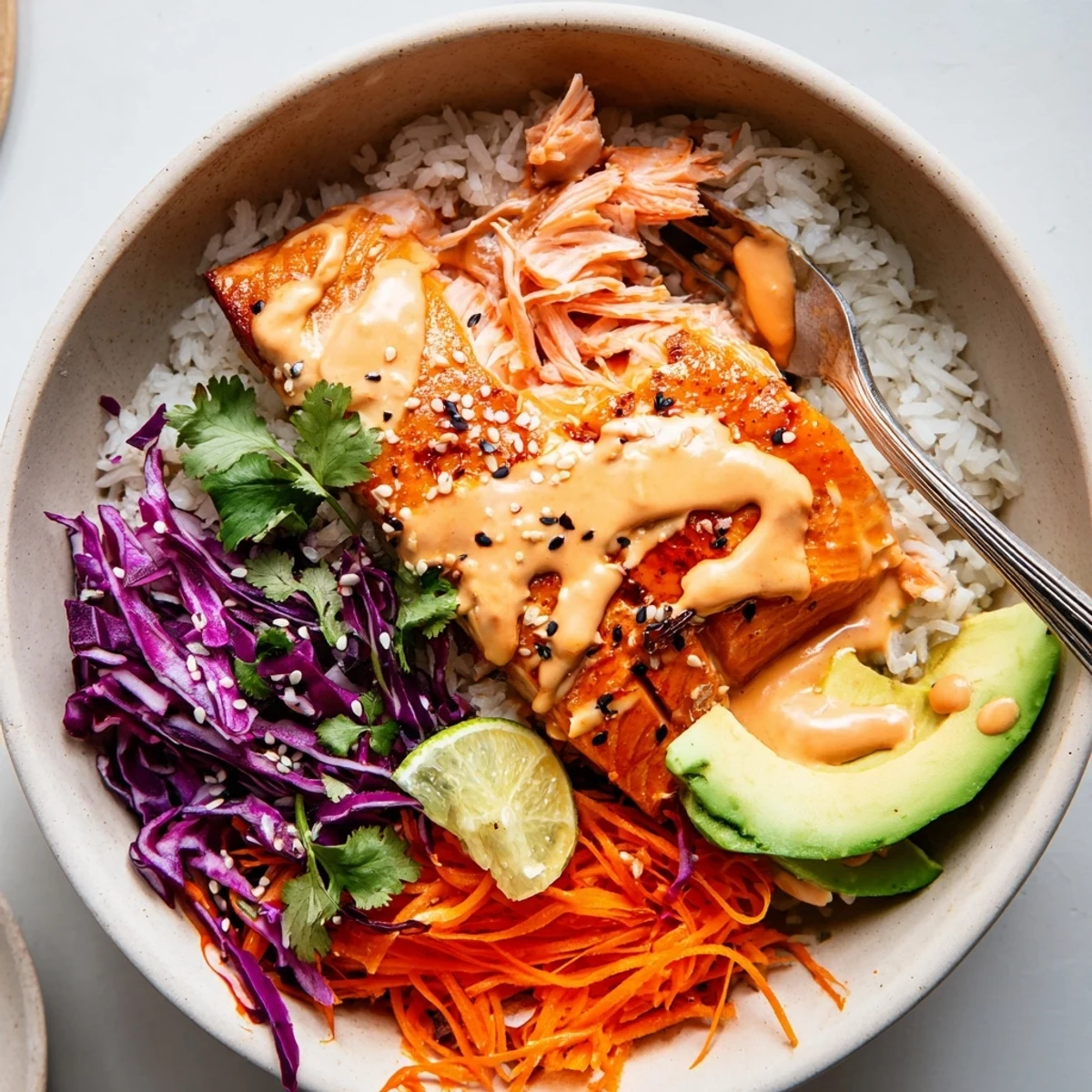 Bang Bang Salmon Bowls Recipe with roasted salmon, creamy spicy sauce, lime wedge