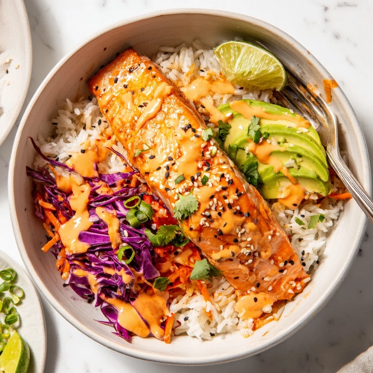 Weeknight Bang Bang Salmon Bowls Recipe served warm with crunchy cabbage and cilantro