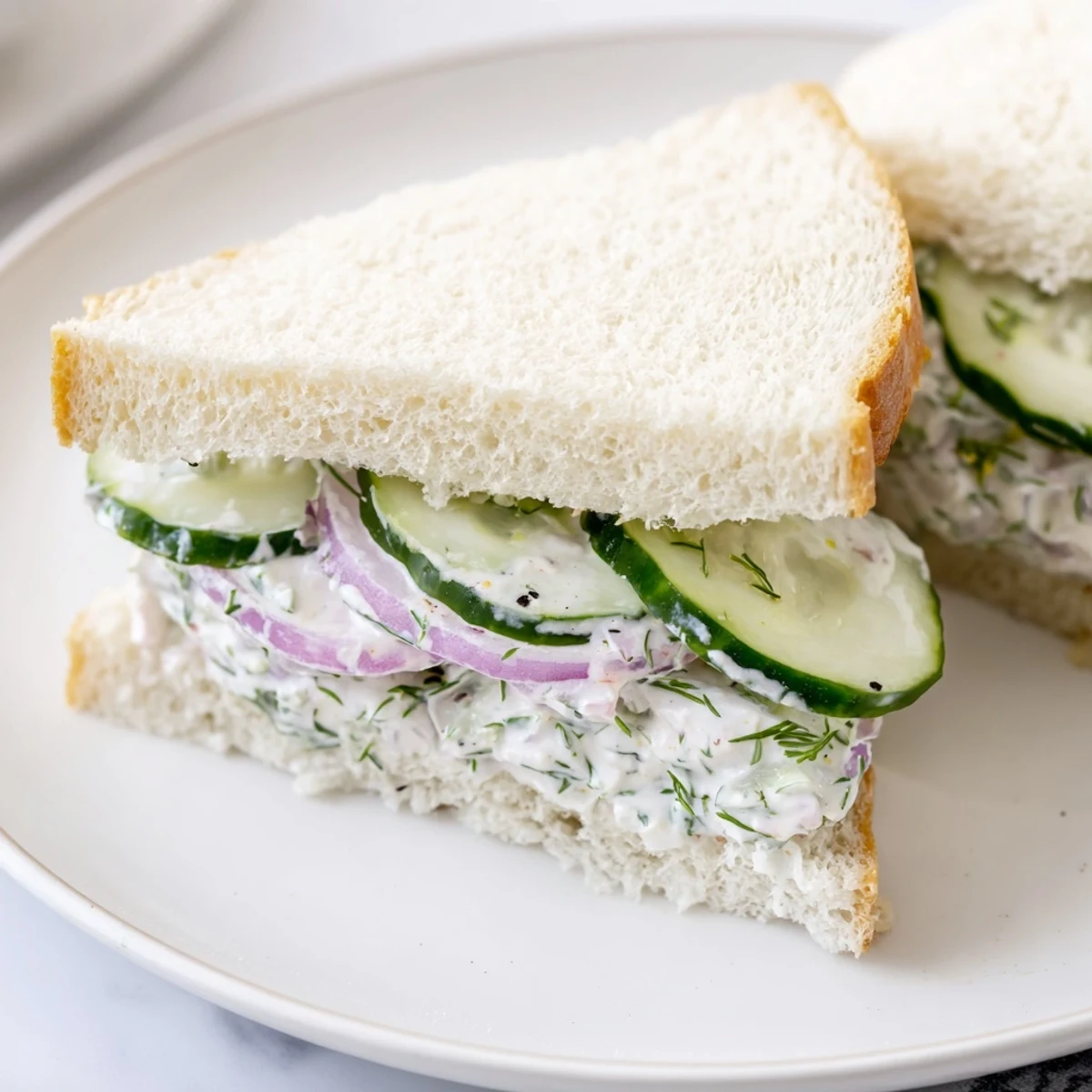 Quick Cucumber Salad Sandwiches with creamy dill dressing, stacked on soft bread