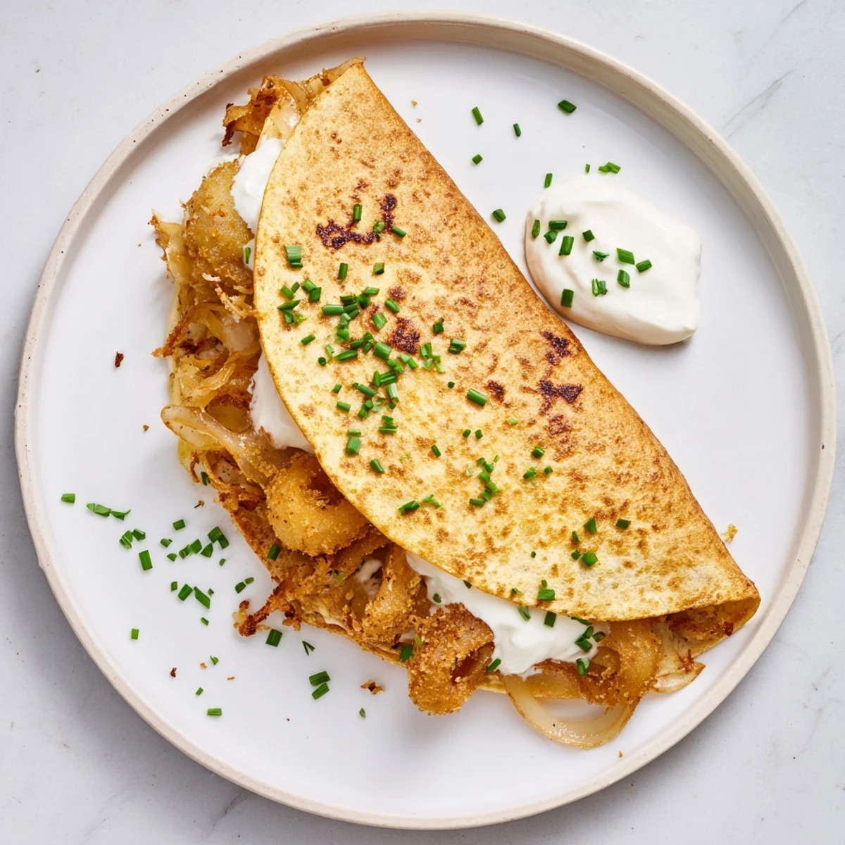 Sliced Tex-Mex quesadilla revealing crunchy battered onion rings and gooey mozzarella inside