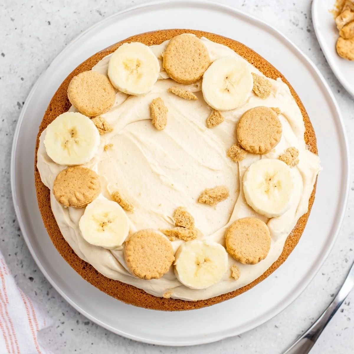 Decadent banana pudding cake dessert with alternating layers of custard and sliced ripe bananas