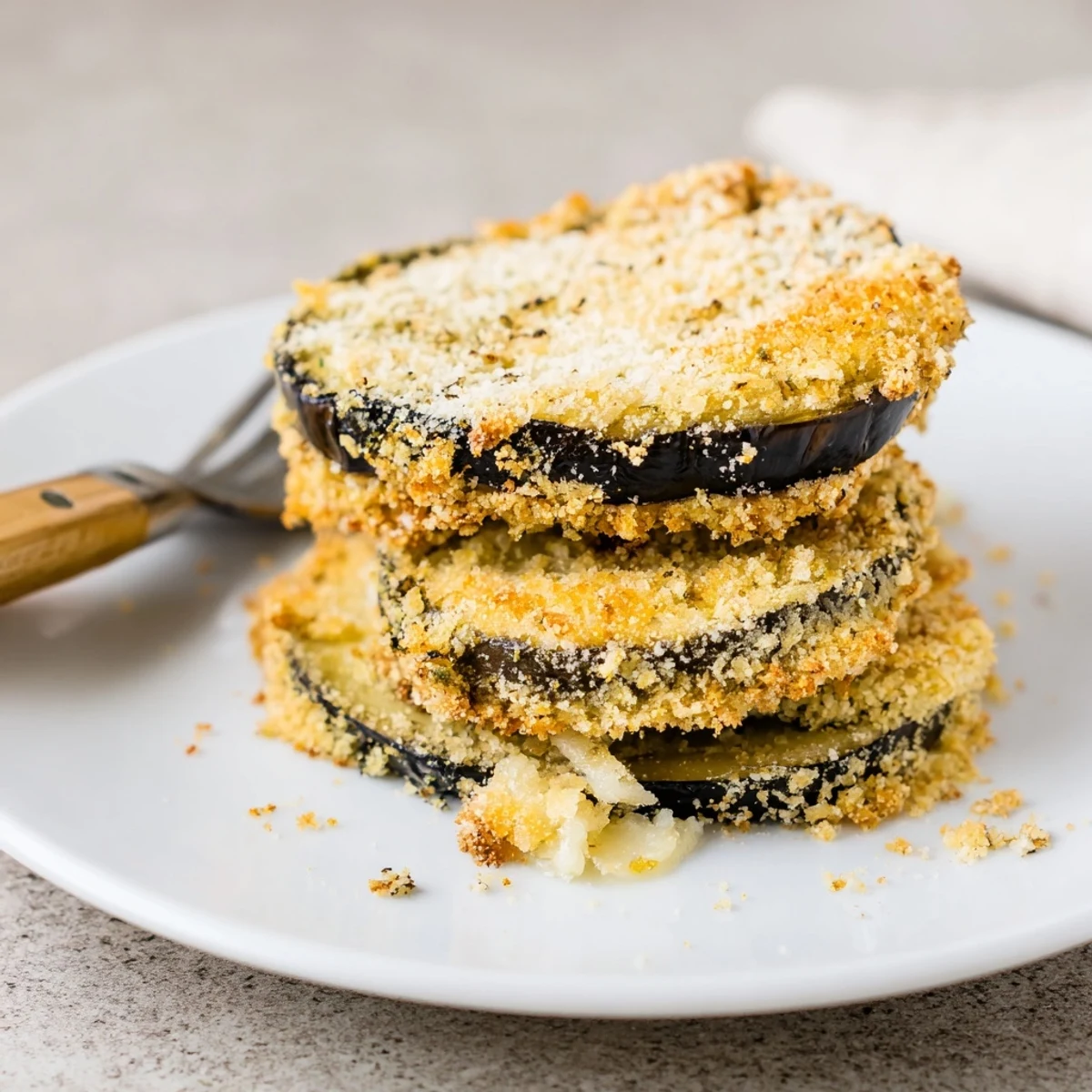 Crispy Baked Eggplant rounds, golden-brown and crunchy, served with marinara dipping sauce