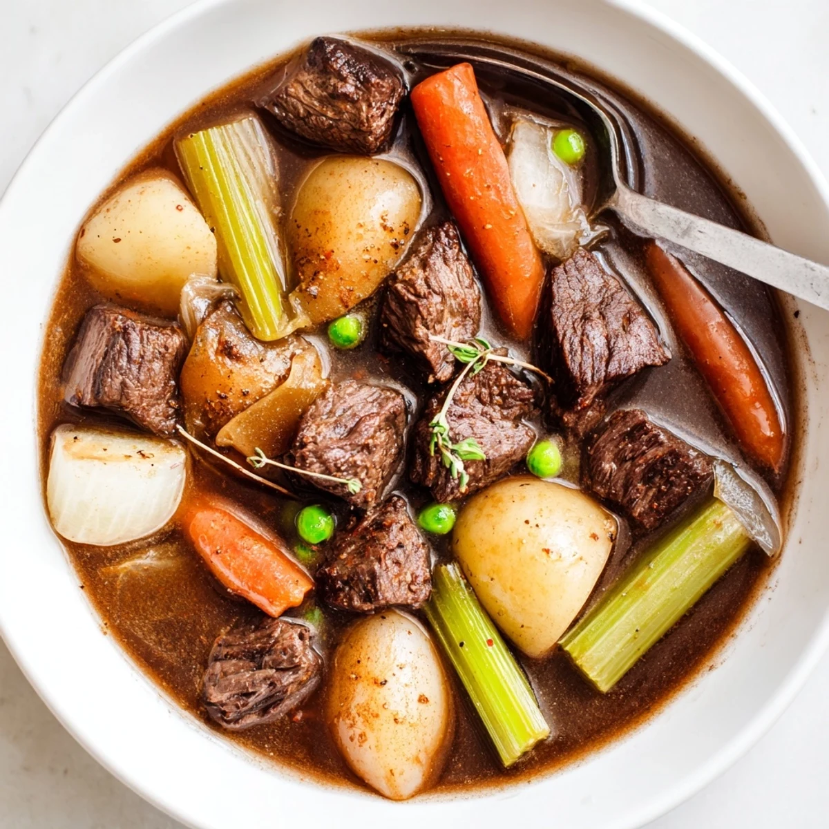 Dutch oven of slow-simmered Beef Stew, aromatic herbs and thickened gravy