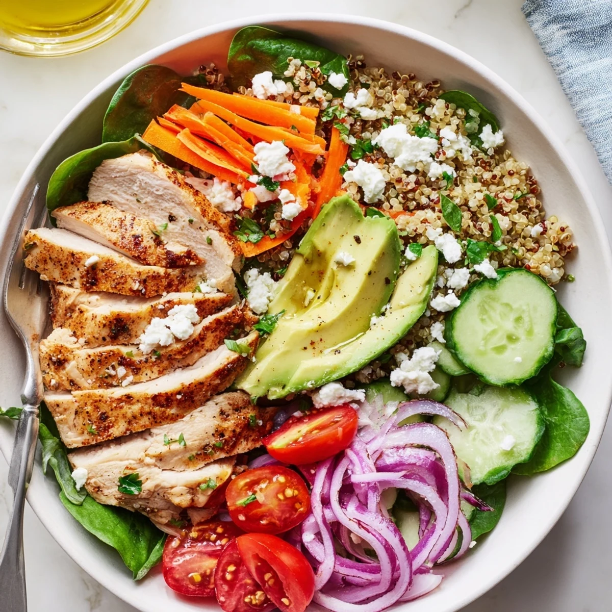 Smoky sliced chicken grain bowl drizzled with bright lemon herb dressing close-up